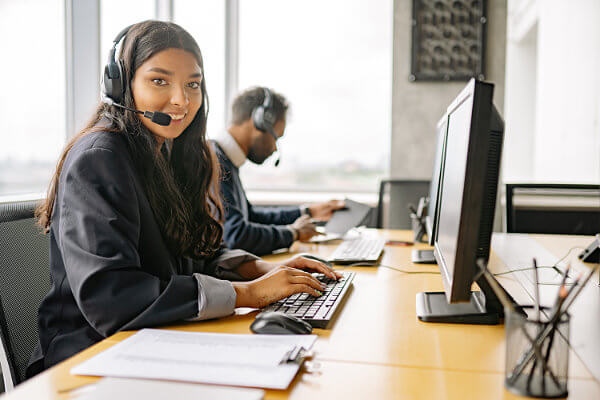 Woman with headset in contact center: IPT voice systems consultants R M Shoemaker